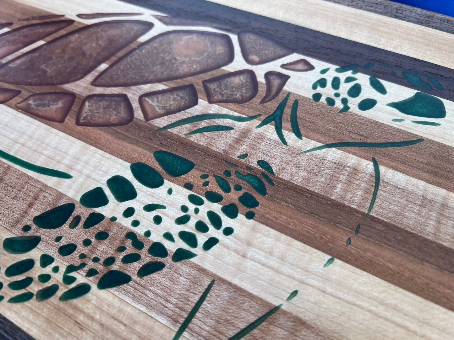 close up of sea turtle epoxy inlay on a hardwood charcuterie board