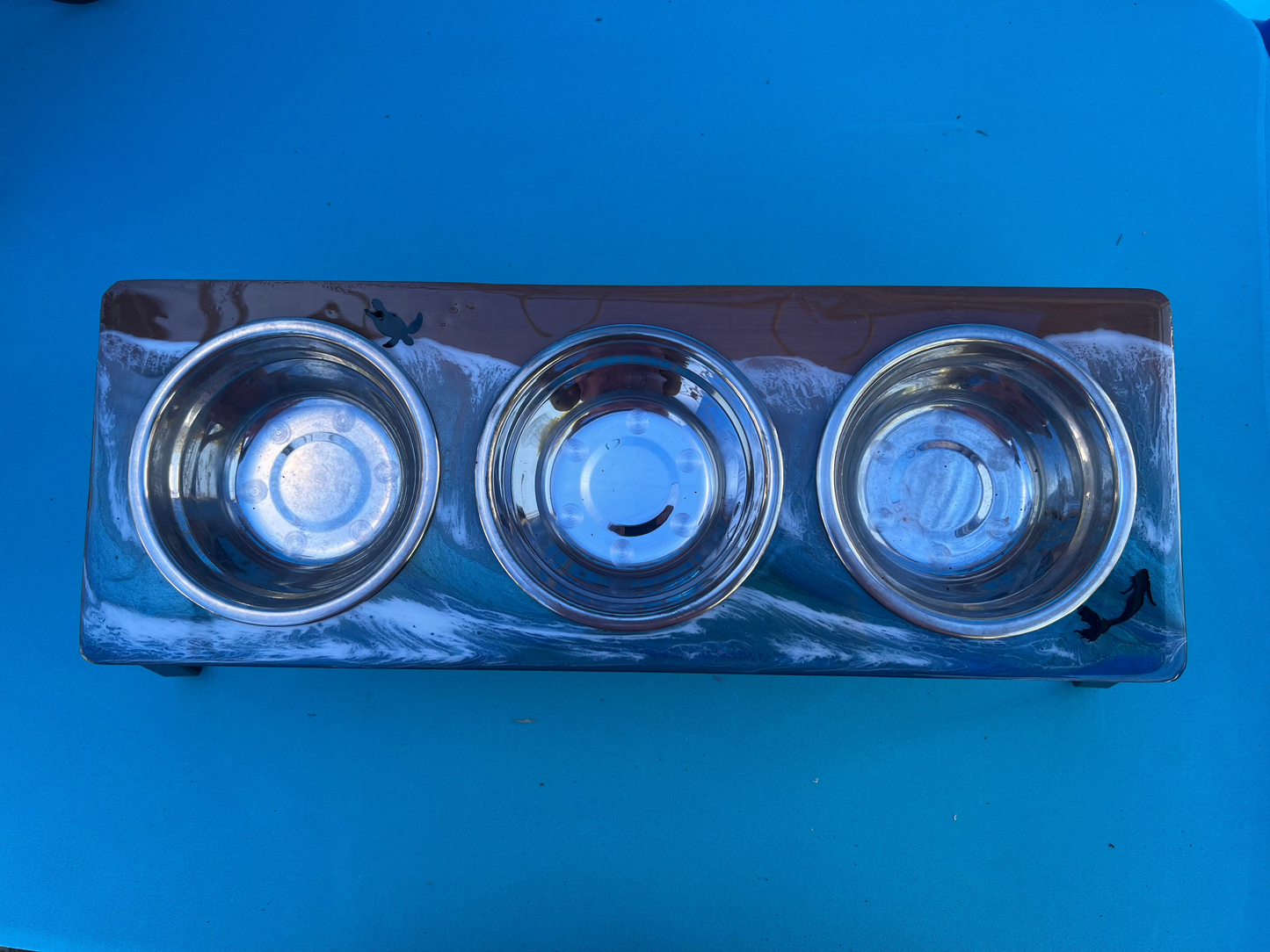 small animal bowl feeding stand with three bowls with an epoxy ocean on it with a mermaid and turtle swimming in the water