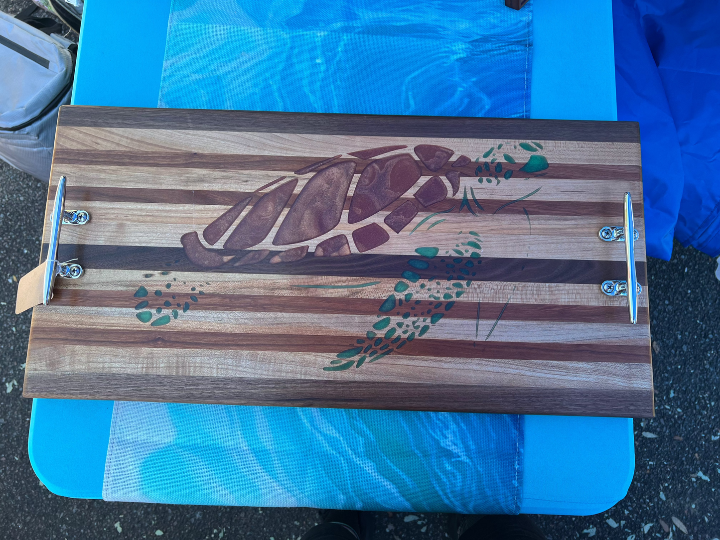 Wooden cutting board with a turtle design on a blue background